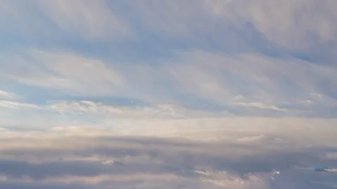 Formation and rapid movement of white clouds of different shapes in the blue sky Stock Footage 103377818