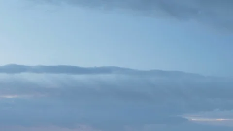 Formation and rapid movement of white clouds of different shapes in the blue sky Stock Footage 103377866