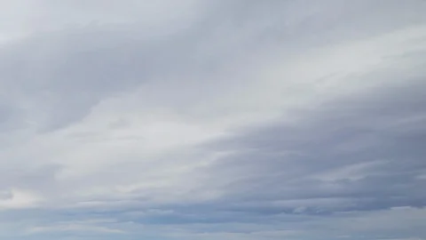 Formation and rapid movement of white clouds of different shapes in the blue sky Stock Footage 103377977