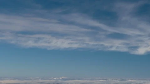 Formation and rapid movement of white clouds of different shapes in the blue sky Stock Footage 103378037