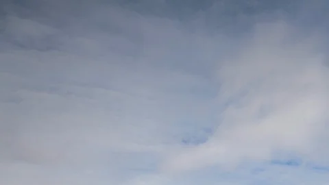 Formation and rapid movement of white clouds of different shapes in the blue sky Stock Footage 103378250