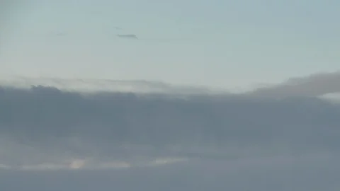 Formation and rapid movement of white clouds of different shapes in the blue sky Stock Footage 103378307