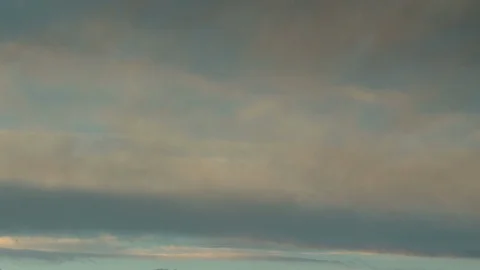 Formation and rapid movement of white clouds of different shapes in the blue sky Stock Footage 103378446