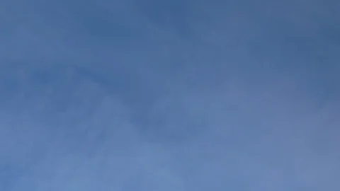 Formation and rapid movement of white clouds of different shapes in the blue sky Stock Footage 103378523