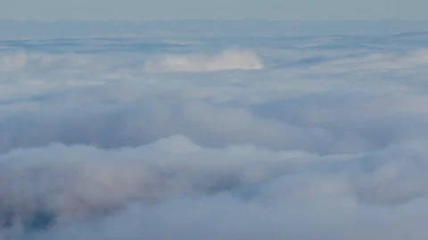 Formation and rapid movement of white clouds of different shapes in the blue sky Stock Footage 103378540