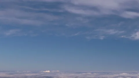 Formation and rapid movement of white clouds of different shapes in the blue sky Stock Footage 103378561