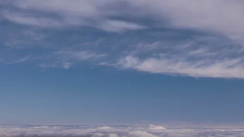 Formation and rapid movement of white clouds of different shapes in the blue sky Stock Footage 103378710