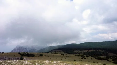 The formation of clouds between the mountains and the sea. Black Sea. Summer 動画素材 62294957