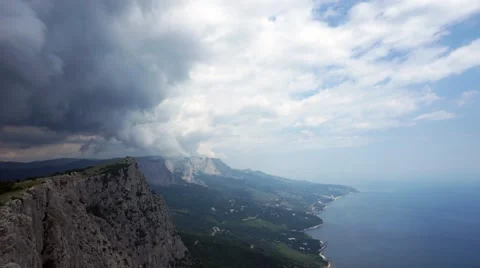 The formation of clouds between the mountains and the sea. Black Sea. Summer Stock Footage
