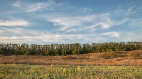 The formation of clouds over autumn endless green fields of grass Stock Footage 67735380