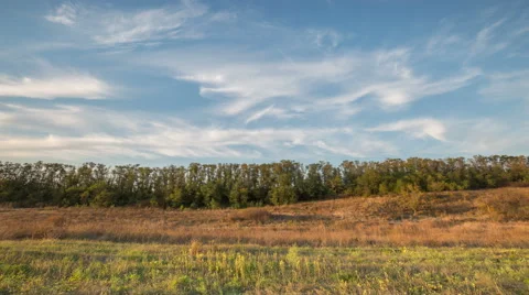 The formation of clouds over autumn endless green fields of grass Stock Footage 67736716