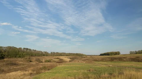 The formation of clouds over autumn endless green fields of grass Stock Footage 67737605