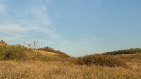 The formation of clouds over autumn endless green fields of grass Stock Footage 67738643