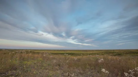 The formation of clouds over autumn endless green fields of grass Stock Footage 67740657