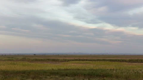 The formation of clouds over autumn endless green fields of grass Stock Footage 67742448