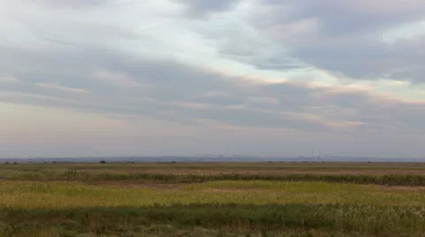 The formation of clouds over autumn endless green fields of grass Stock Footage 67745057