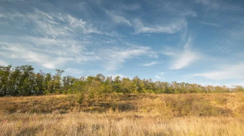The formation of clouds over autumn endless green fields of grass Stock Footage 67748579