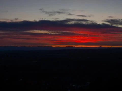 Formation of clouds paint the sky red at sunset. Evening view twilight Sky. Stock Photos