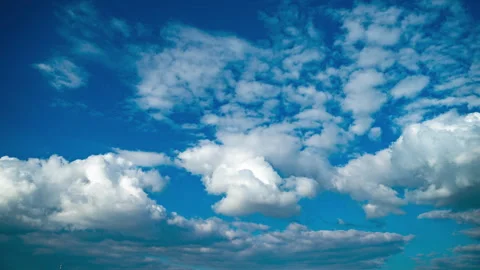 Formation of large white cumulus clouds. Evening blue sky with multi-layered Video stock 247702369