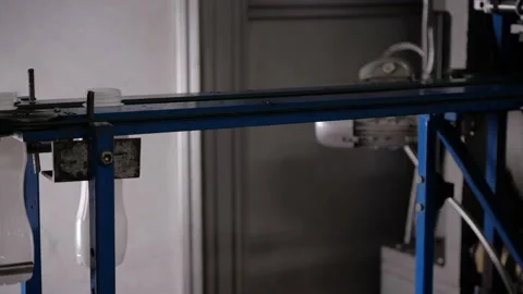 Formation of PET containers by internal inflating on the conveyor Stock Footage 170668326