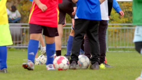 Formation of a queue of players, many legs of athletes with a ball on the field Stock Footage 294769730