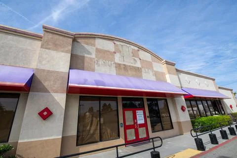 Former Chuck E Cheese restaurant entrance logo sign silhouette. Storefront Stock Photos