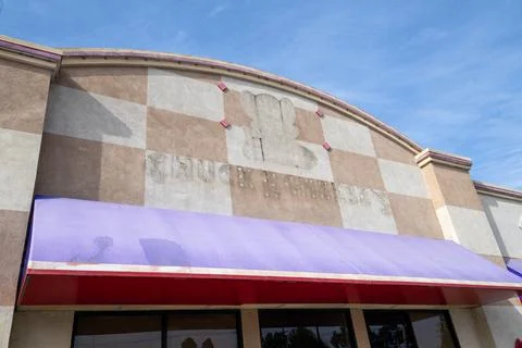 Former Chuck E Cheese restaurant entrance logo sign silhouette. Storefront Stock Photos