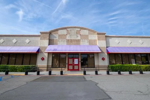 Former Chuck E Cheese restaurant entrance logo sign silhouette. Storefront Stock Photos