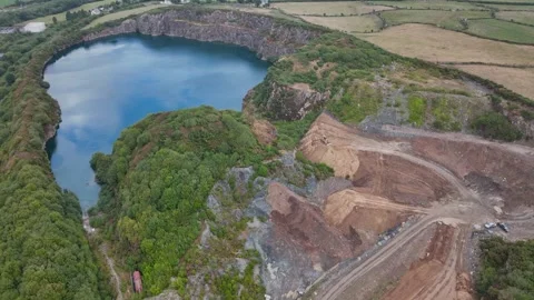Former quarry landscape being restored as trucks deliver soil Stock Footage 345086884