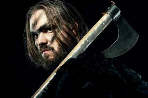 Formidable viking in armor and axe on black background Stock-Fotos