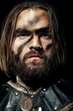 Formidable viking in armor on black background Stock Photos