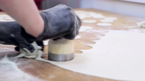 Forming dough into circles for making dumplings Stock Footage 179049886