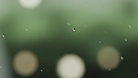 Forming from light drizzle, water droplets gathering and running on window with Stock Footage 341889685