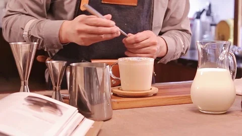 Forming the Pattern on the Tea Latte Stock Footage 121714977