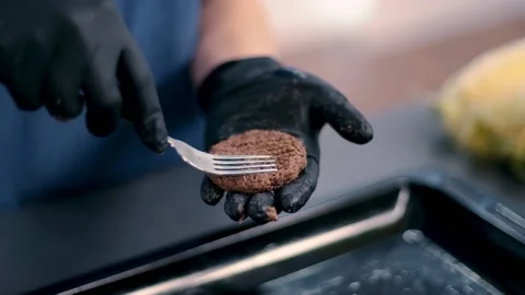 Forming patty with a fork and put on the metalic tray. Process of making healthy Stock Footage 135236710