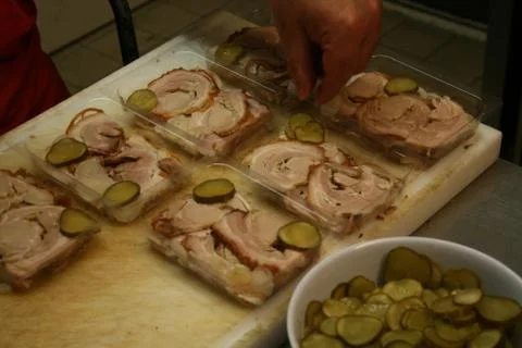 Forms filled with different meet slices and cucumber covered with galantine 写真素材