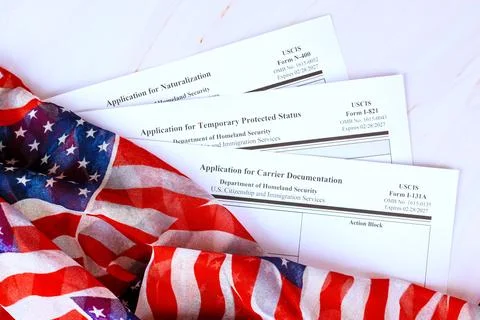 Forms for immigration processes on table with an American flag Stock Photos