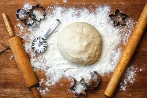 Forms for squeezing the dough. dough on the table with dough tools. Stock Photos