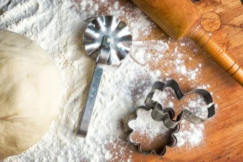 Forms for squeezing the dough. dough on the table with dough tools. Stock Photos