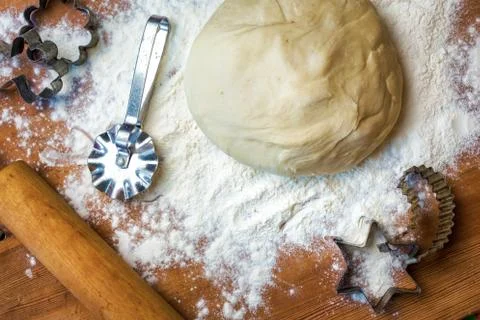 Forms for squeezing the dough. dough on the table with dough tools. Stock Photos