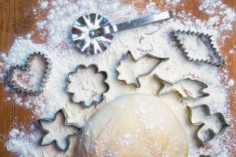 Forms for squeezing the dough. dough on the table with dough tools. Stock Photos
