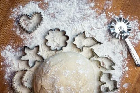 Forms for squeezing the dough. dough on the table with dough tools. Stock Photos