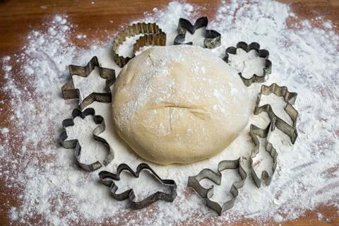 Forms for squeezing the dough. dough on the table with dough tools. Stock Photos