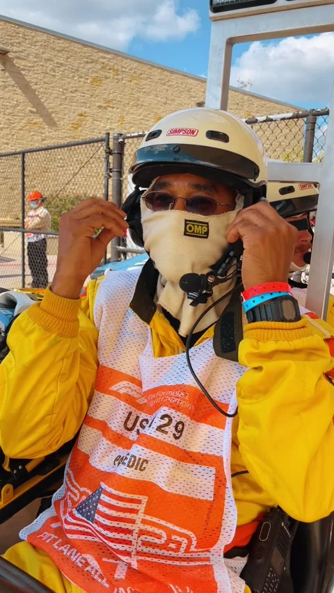 Formula 1 paramedic in yellow fire suit and helmet Stock Footage 331600590