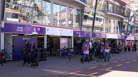 Formula E pit lane with team garages and media crew in Monaco in 4K Stock Footage 316673189