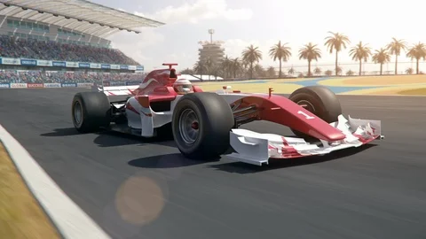 Formula one race car driving past camera Stock Footage