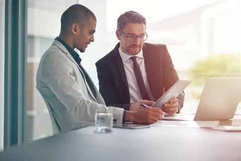 Formulating new ideas. two businessmen having an office meeting. Stock Photos