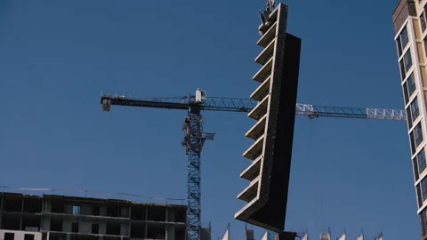 Formwork is lifted on a tower crane at a construction site Stock Footage 251903687