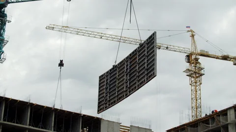 Formwork panel lifted by tower crane on construction site Stock Footage 326825663