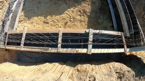 Formwork with reinforcing iron in striped foundations of a building Stock Footage 141450367